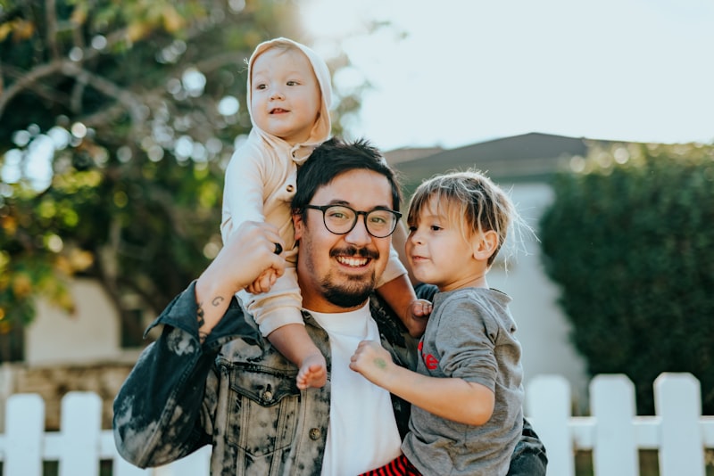 Father embracing children, representing family support and character letters